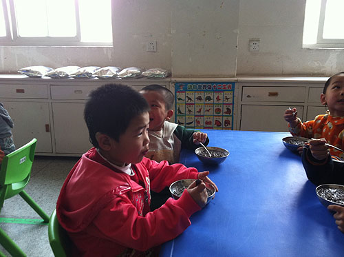 图为陕西省聋儿康复中心的孩子在食用蜜儿餐