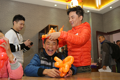 图为金豆哥哥为残疾儿童表演气球魔术